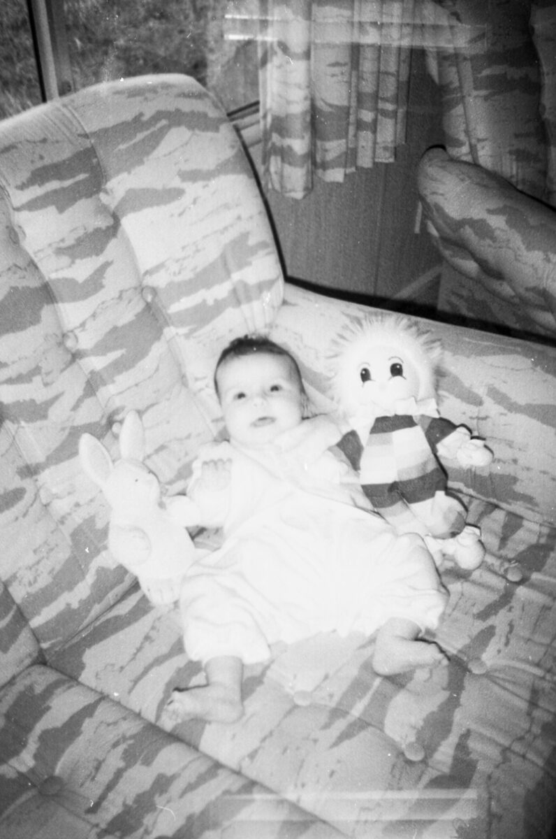 Photos from film found in old cameras - A baby with a toy on a sofa