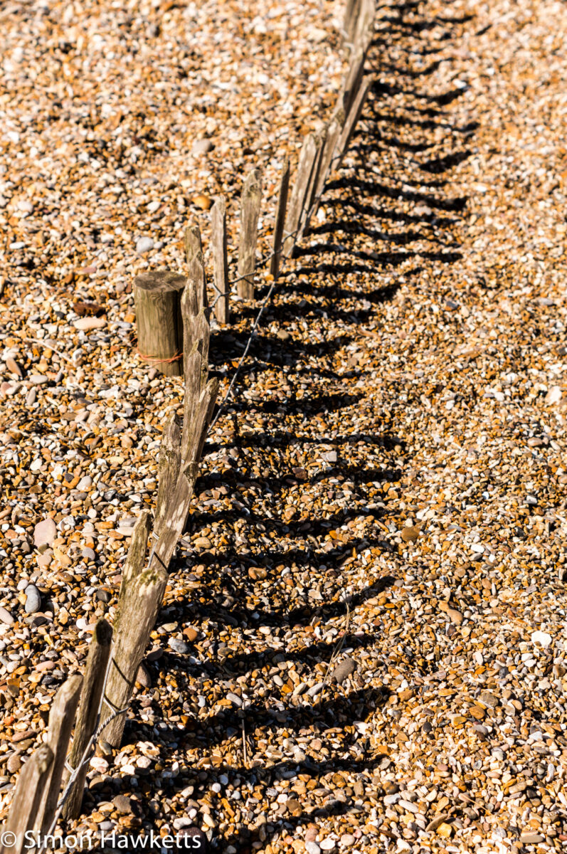 Dunwich Heath Suffolk pictures - A line of fence posts on the pebble beach