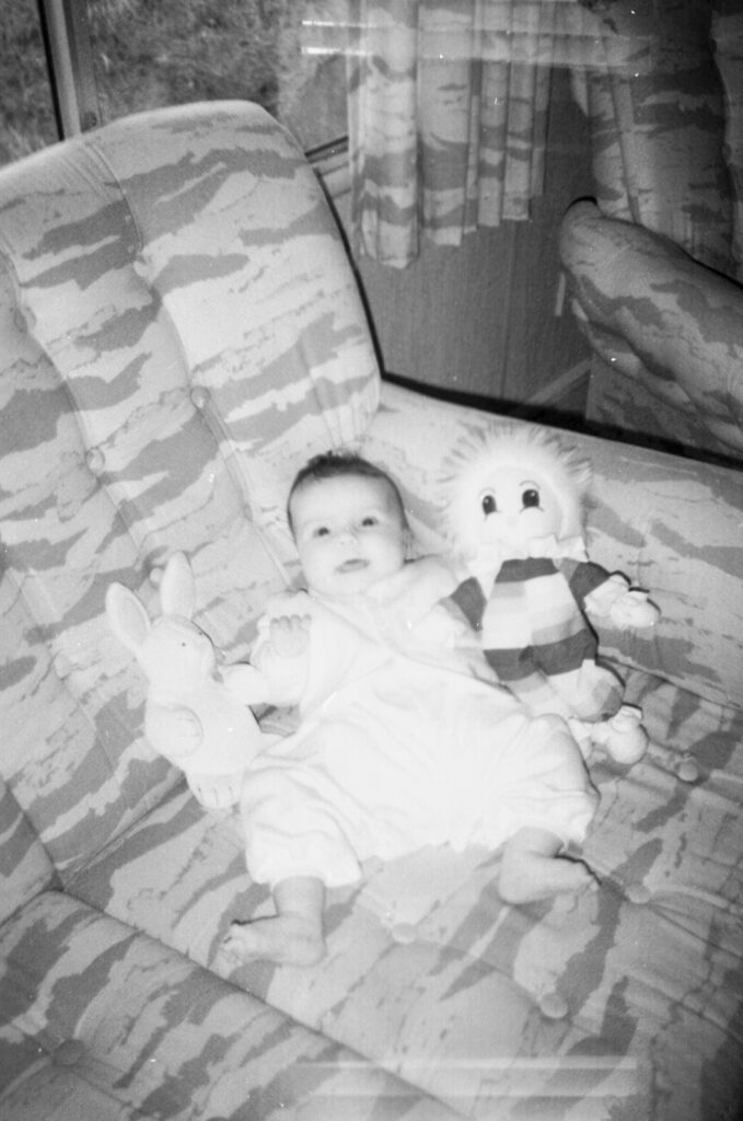 Photos from film found in old cameras - A baby with a toy on a sofa