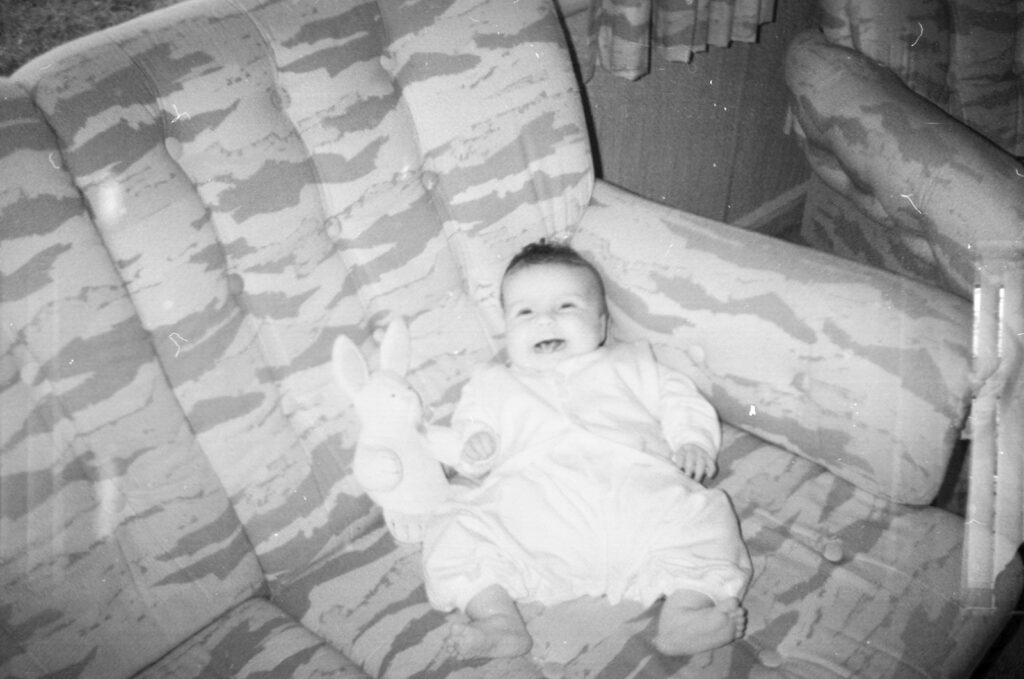 Photos from film found in old cameras - A baby with a toy on a sofa
