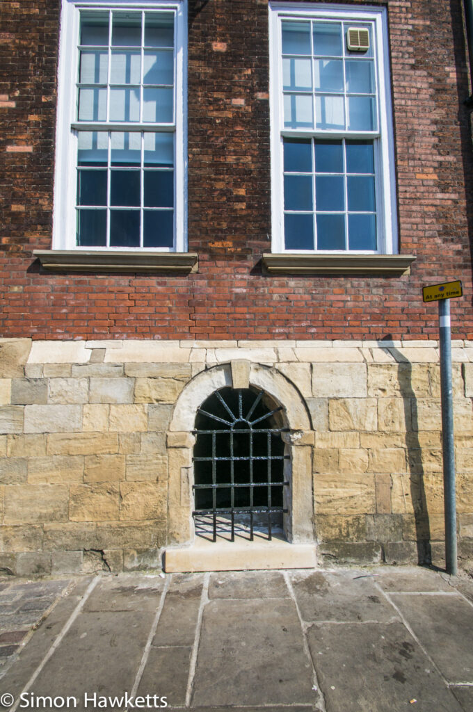 Windows and a gated entrance in a house by the river in York