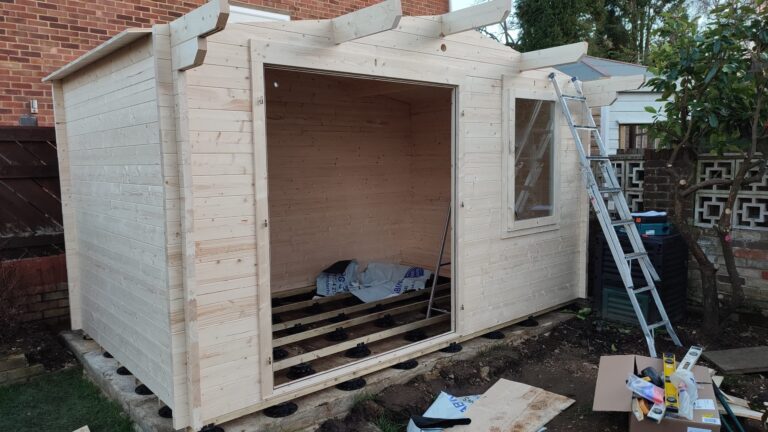 A picture of a partially assembled Dunster House log cabin