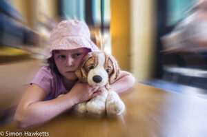 Picture of a small girl with her toy - radial blur added in photoshop