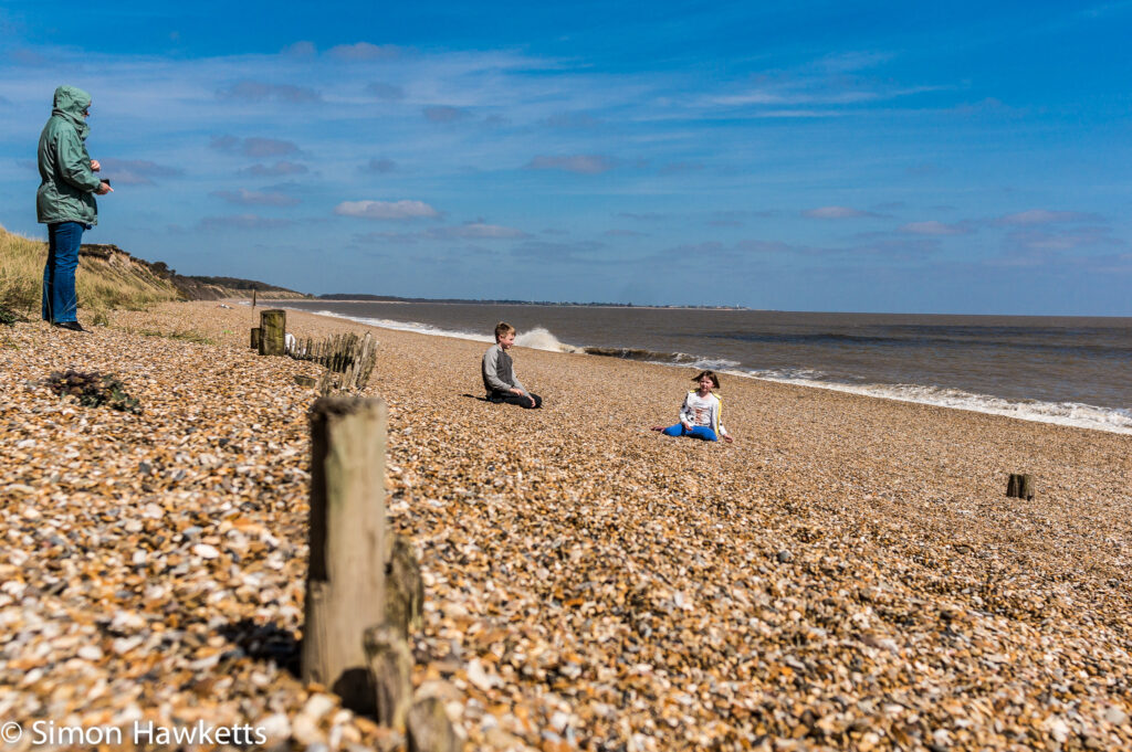 Dunwich Heath Suffolk pictures - A family playing on the beach in the background