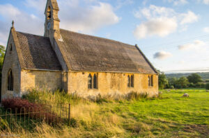 A church in the Gloucestershire countryside bathed in evening sunshine
