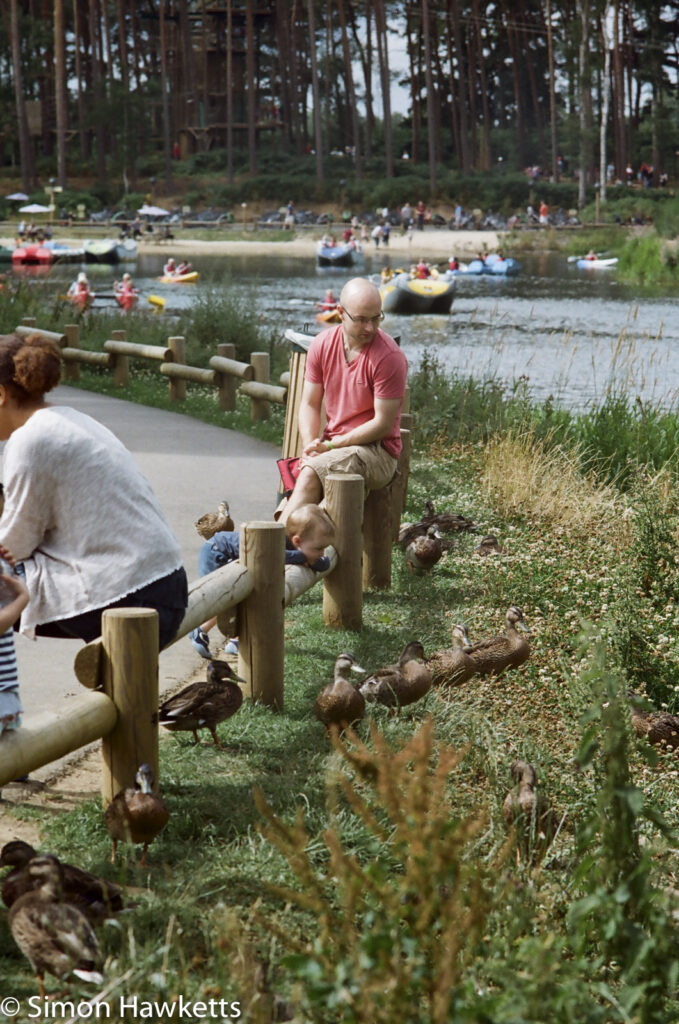 miranda g slr with kodak gold 400 sample picture people sitting on a low fence looking at ducks in centreparcs forest
