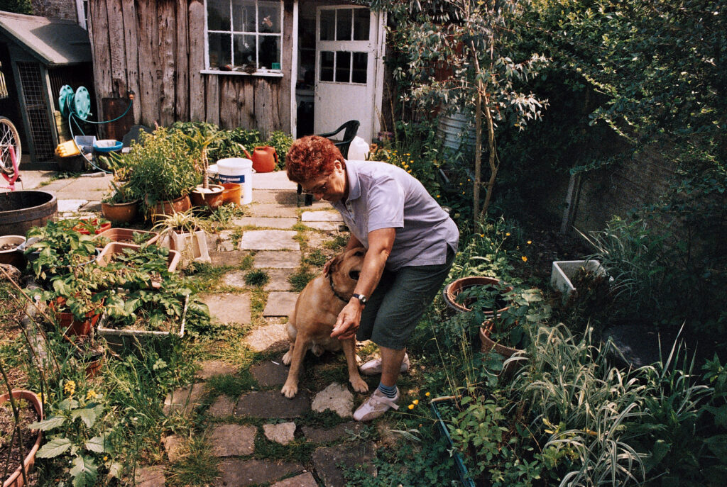 Photos from film found in old cameras - a woman playing with a dog in a garden