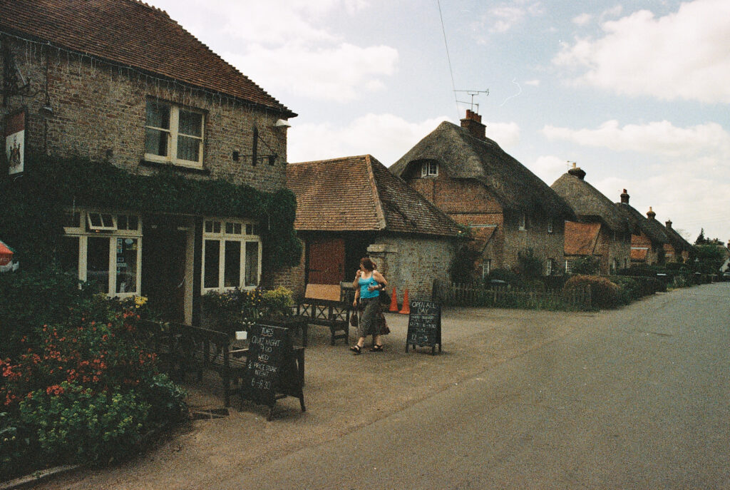 Photos from film found in old cameras - a woman outside a pub